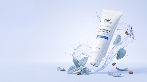 OrreNaturals Hair Revival Ampoule tube with a water splash and mint leaves